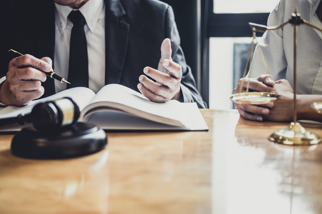 male-lawyer-or-counselor-working-in-courtroom-have-meeting-with-client-are-consultation-with-e1622361295697.jpg